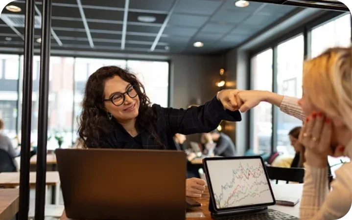 Two professionals celebrating a workforce analytics win